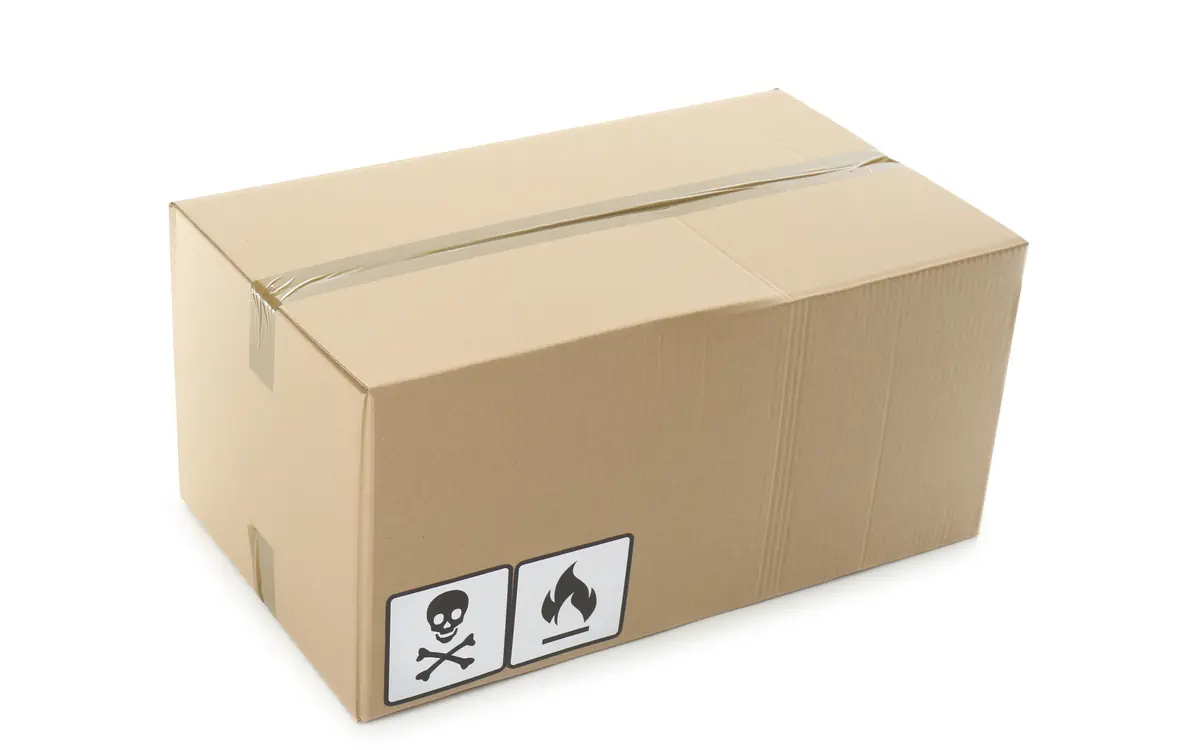 Cardboard box with hazard labels on a white background