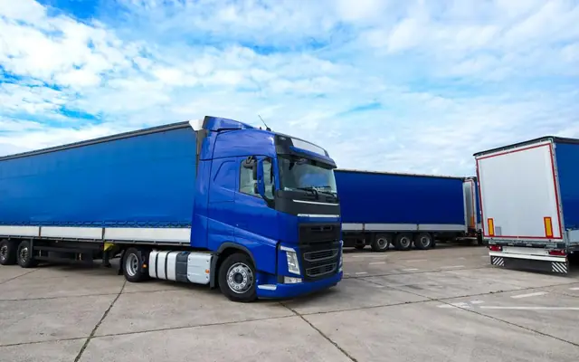 Trucks with semi-trailers parked in a logistics yard