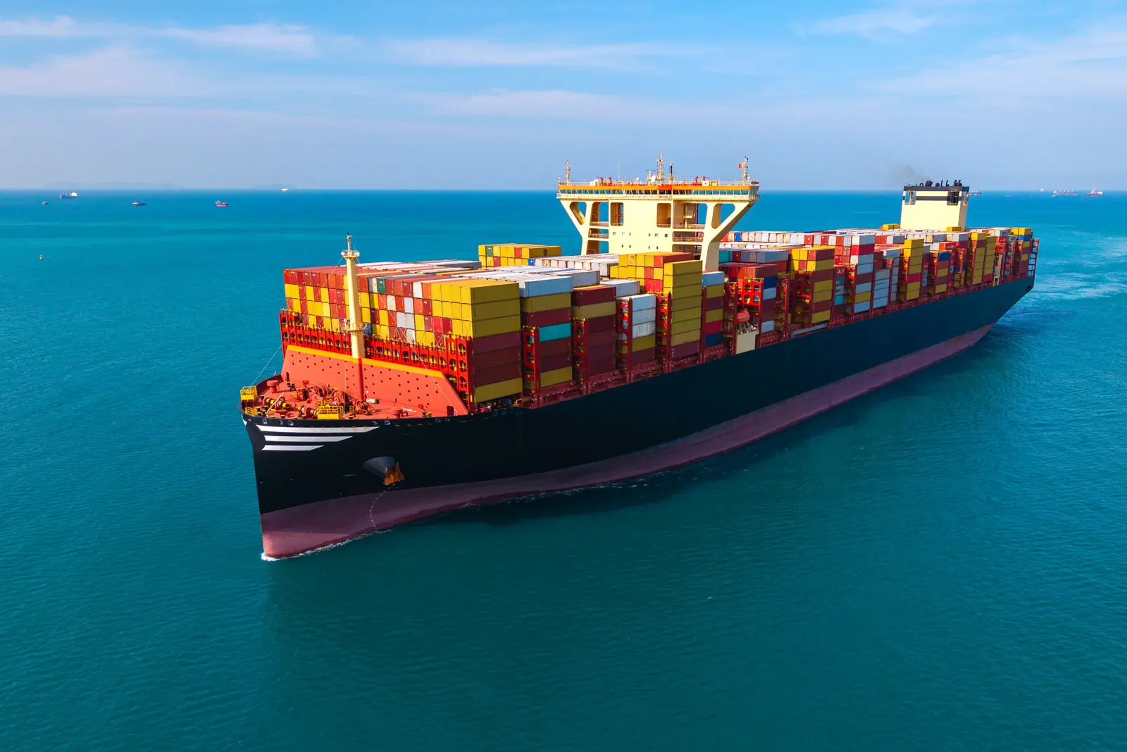 A loaded container ship at sea, seen from above