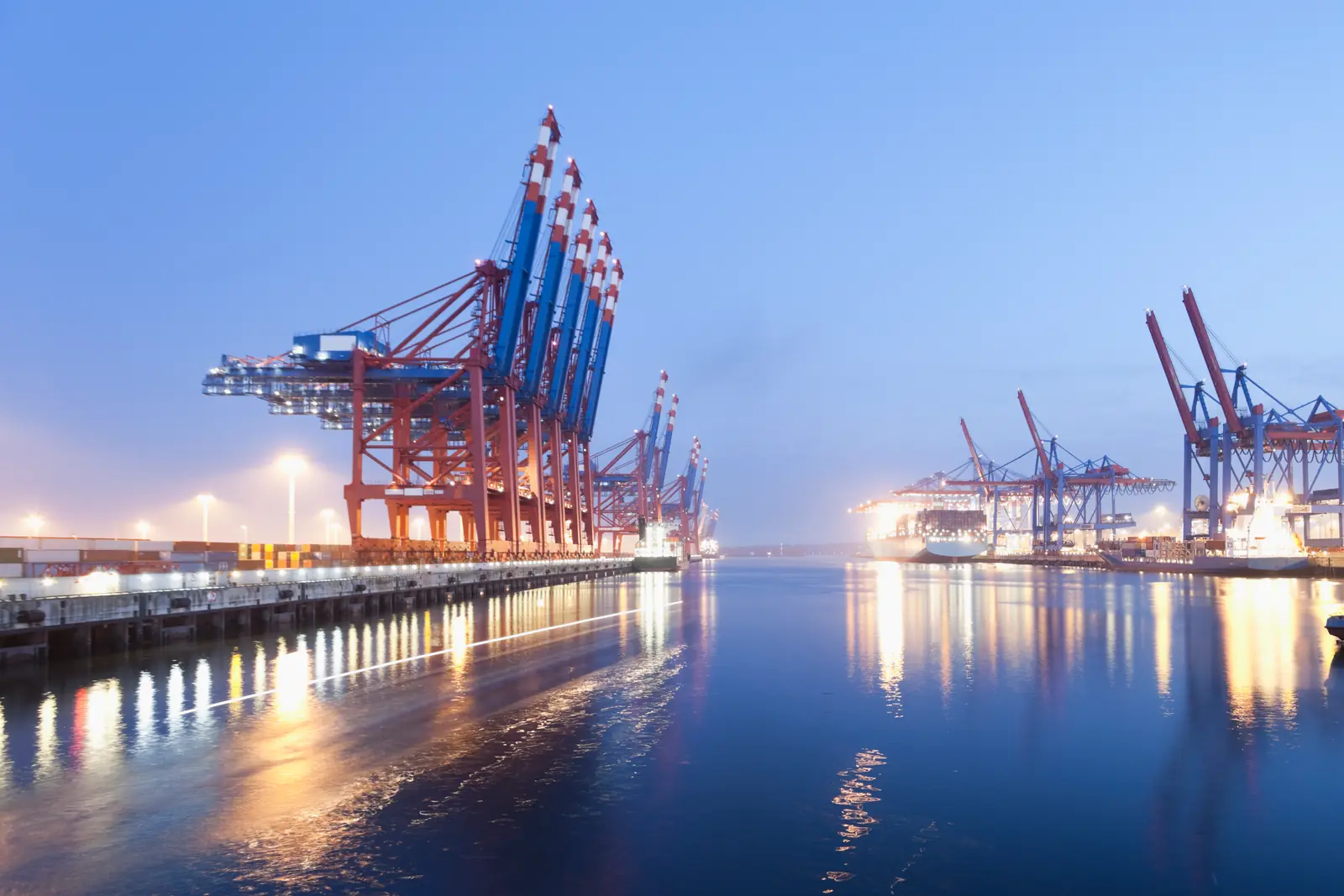 A container terminal with cranes at blue hour