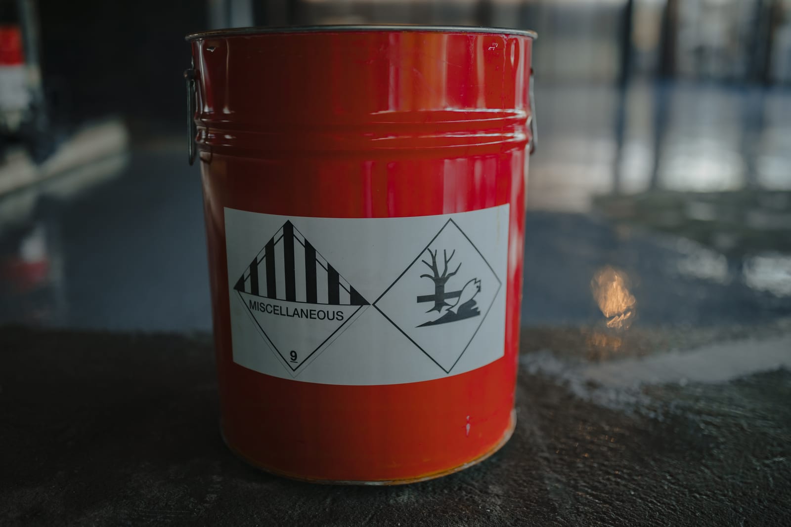 Red jerrycan with ADR hazard labels: class 9 (miscellaneous dangerous goods) and environmentally hazardous